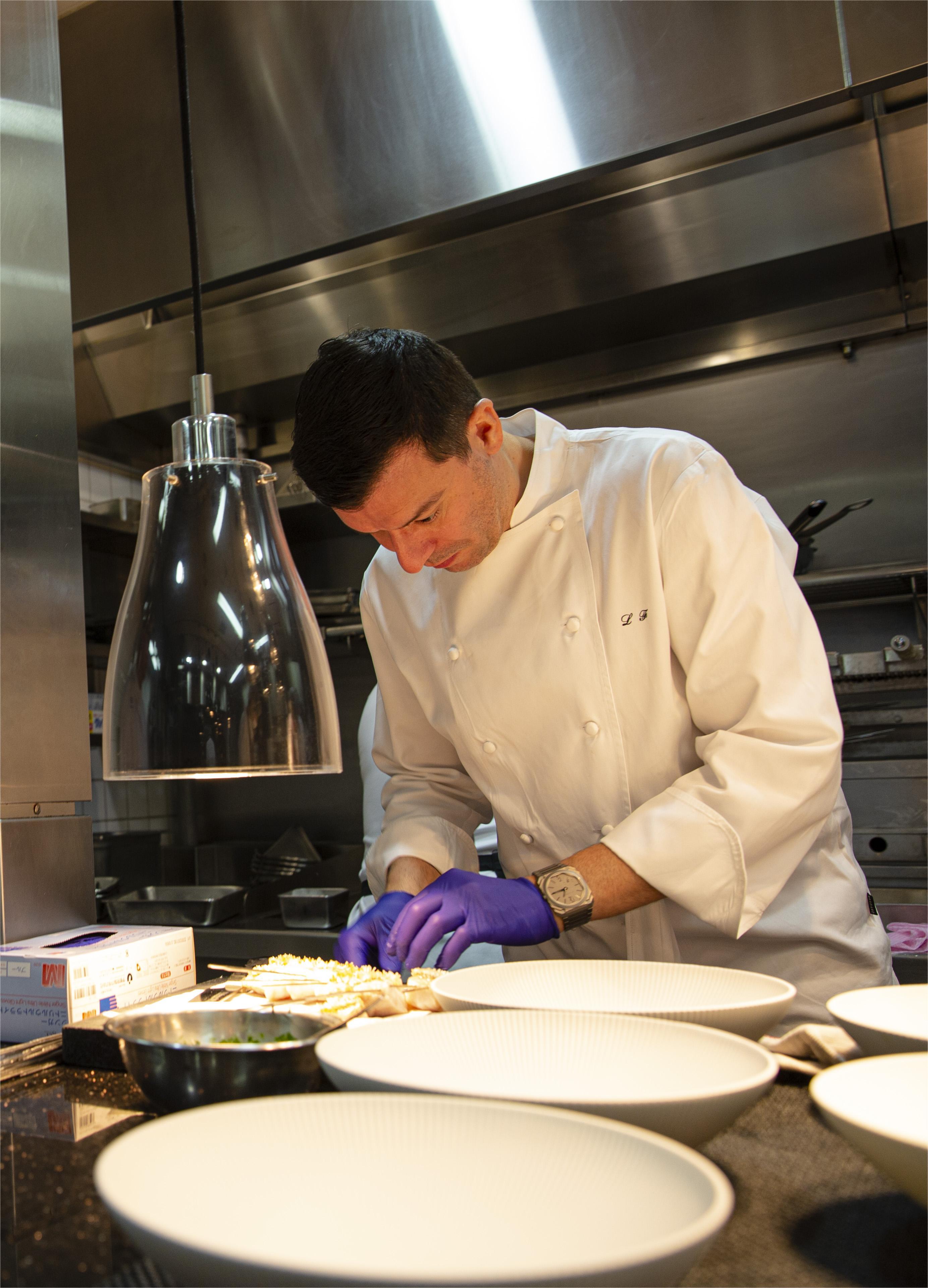 Chef garnishing meat plate